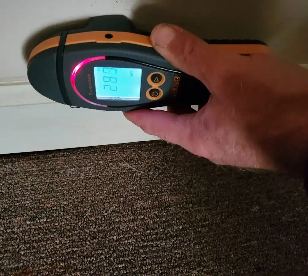 Moisture detection at baseboard during Storm Damage Restoration in Dickinson